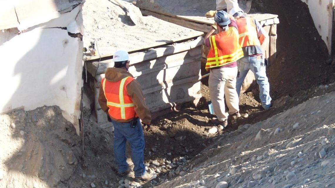 Hanford workers retrieve drums of radioactive waste buried in the center of the nuclear reservation.