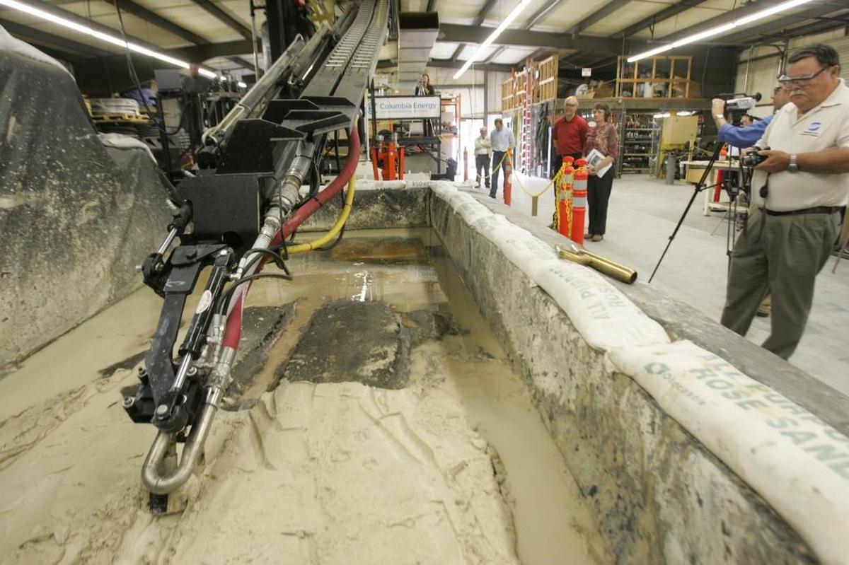 The vacuum Mobile Arm Retrieval System is shown during testing with a waste simulant before the robotic arm vacuum system was used to empty some of the waste from Hanford’s Tank C-105.