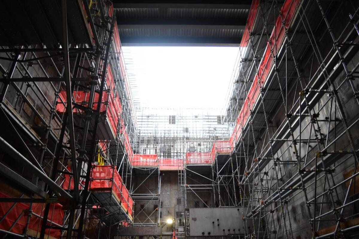 Sunlight shines through an opening above scaffolding installed in the High Level Waste Facility melter cave at the Hanford nuclear reservation’s vitrification plant.