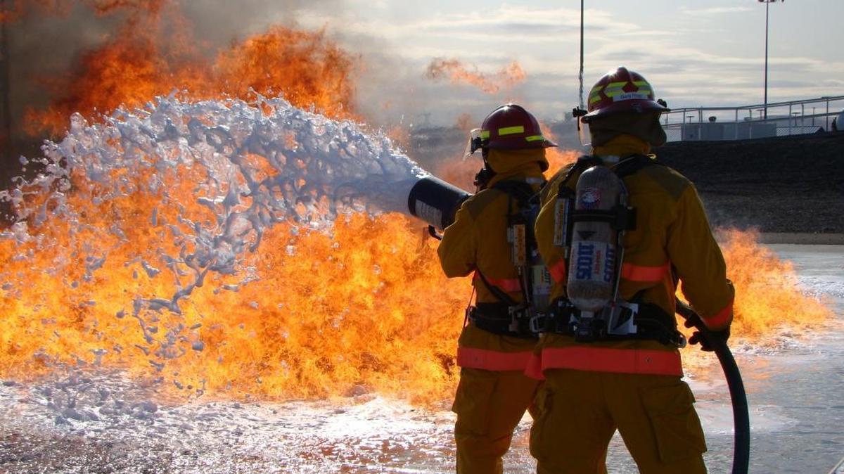 Firefighters train on a concrete pad at the HAMMER training center near Richland equipped to allow them to practice extinguishing flames from a pool of gasoline or other flammable liquid with foam.