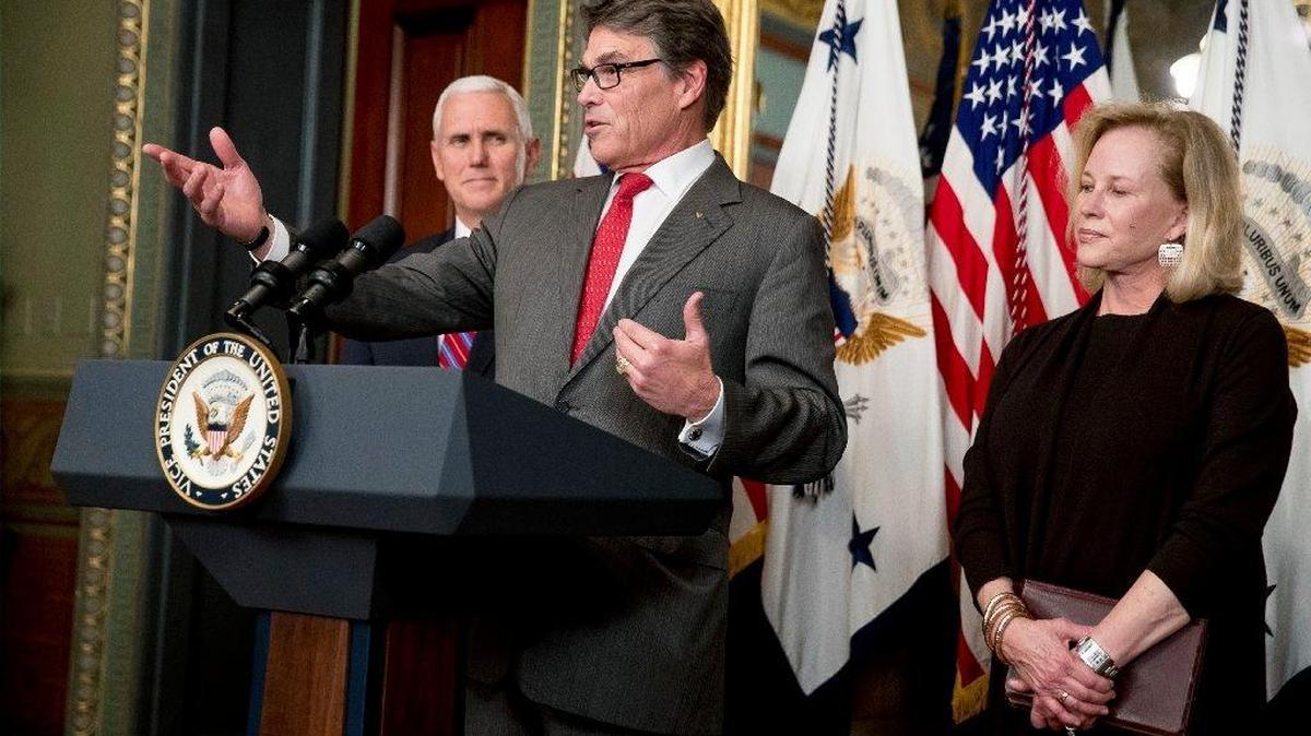 Energy Secretary Rick Perry, second from left, accompanied by his wife Anita, right, and Vice President Mike Pence, left, speaks during a swearing in ceremony Thursday in the Eisenhower Executive Office Building on the White House complex in Washington.