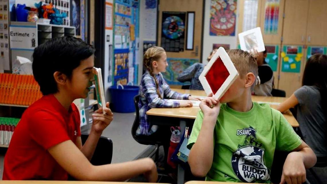 Troy Molnaa, left, and Zac Thomas, look through filters during a science presentation at Lewis and Clark Elementary School. The Department of Energy may cut its payment in lieu of taxes to the Richland School District by 80 percent. Last year the district received $2.6 million.