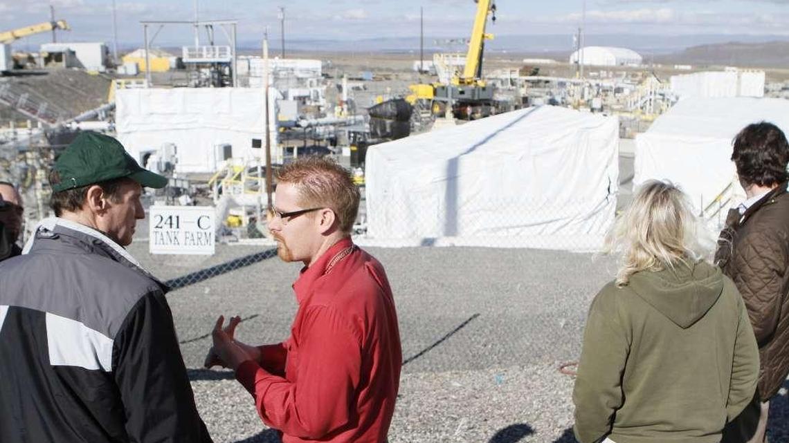 Tom Fletcher, in red, gives Sen. Ron Wyden, D-Ore., left, a tour of the Hanford tank farms.