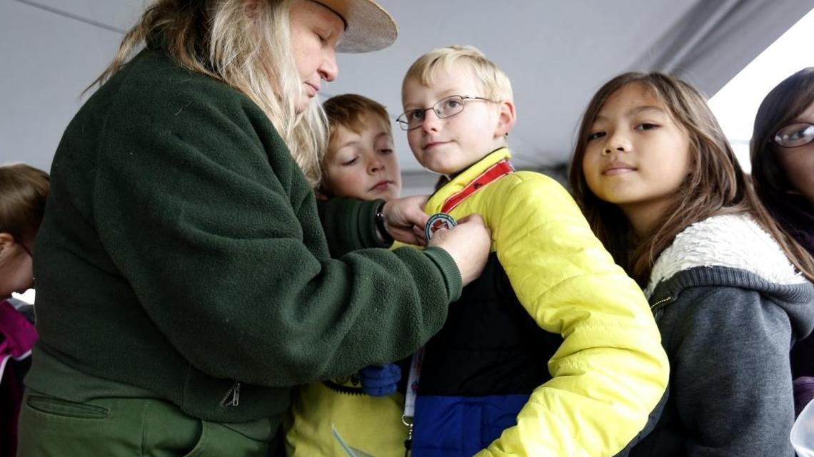 National Parks Service Ranger Fawn Pauer pins Ethan Clifford from White Bluffs Elementary School in Richland during a recent tour of Hanford’s B Reactor. The students were part of a ceremony marking the creation of the Manhattan Project National Historic Park.