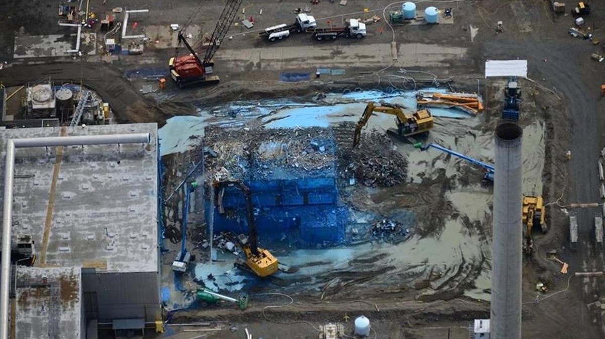 Blue fixative has been sprayed on the Plutonium Reclamation Facility during demolition to help prevent radioactive contamination from becoming airborne.