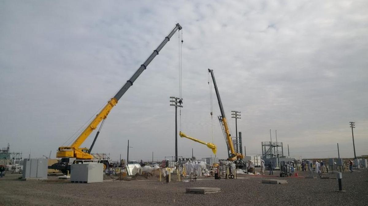 A pump is lifted from double-shell Tank AP-02 to replace it with a more efficient pump for work to accept waste from the Hanford double-shell tank with a leak between its shells.