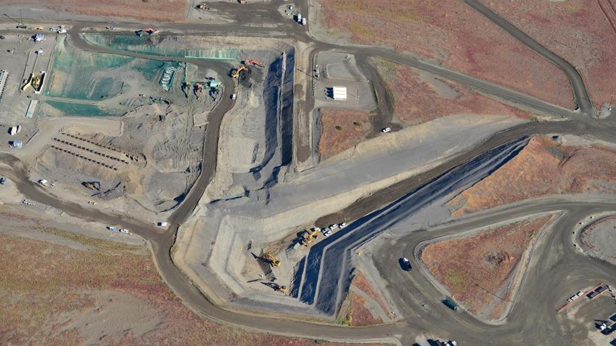 The 618-10 Burial Ground, six miles north of Richland at the Hanford nuclear reservation, had vertically buried pipes filled with waste and trenches. To the right is the hole with a long ramp where contaminated soil was dug up after uranium-contaminated liquid waste had been dumped into the ground.