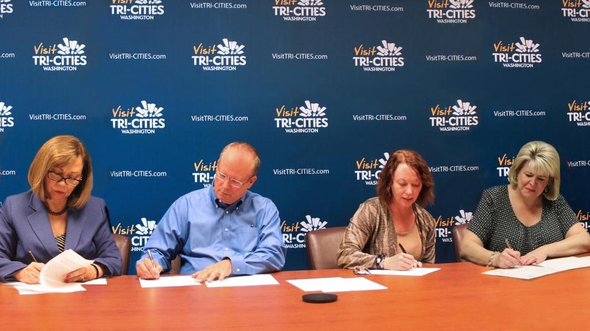 An agreement allowing donations to be accepted for the Hanford portion of the new Manhattan Project National Historical Park is signed by, from left, Kris Watkins, Visit Tri-Cities president; Todd Nelson, president of the Benton-Franklin River Heritage Foundation; Tracy Atkins, interim superintendent of the park, and Colleen French, Department of Energy national park program director at Hanford.