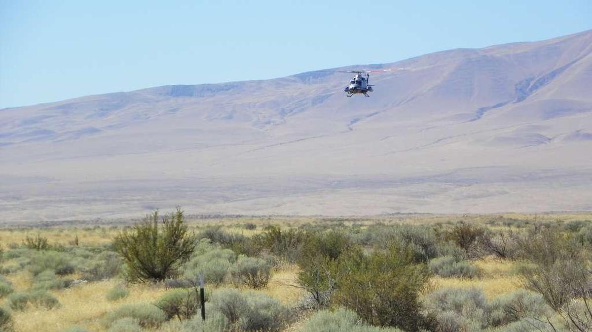 
A helicopter flies low over Hanford in 2009 as it conducts a radiological survey.
