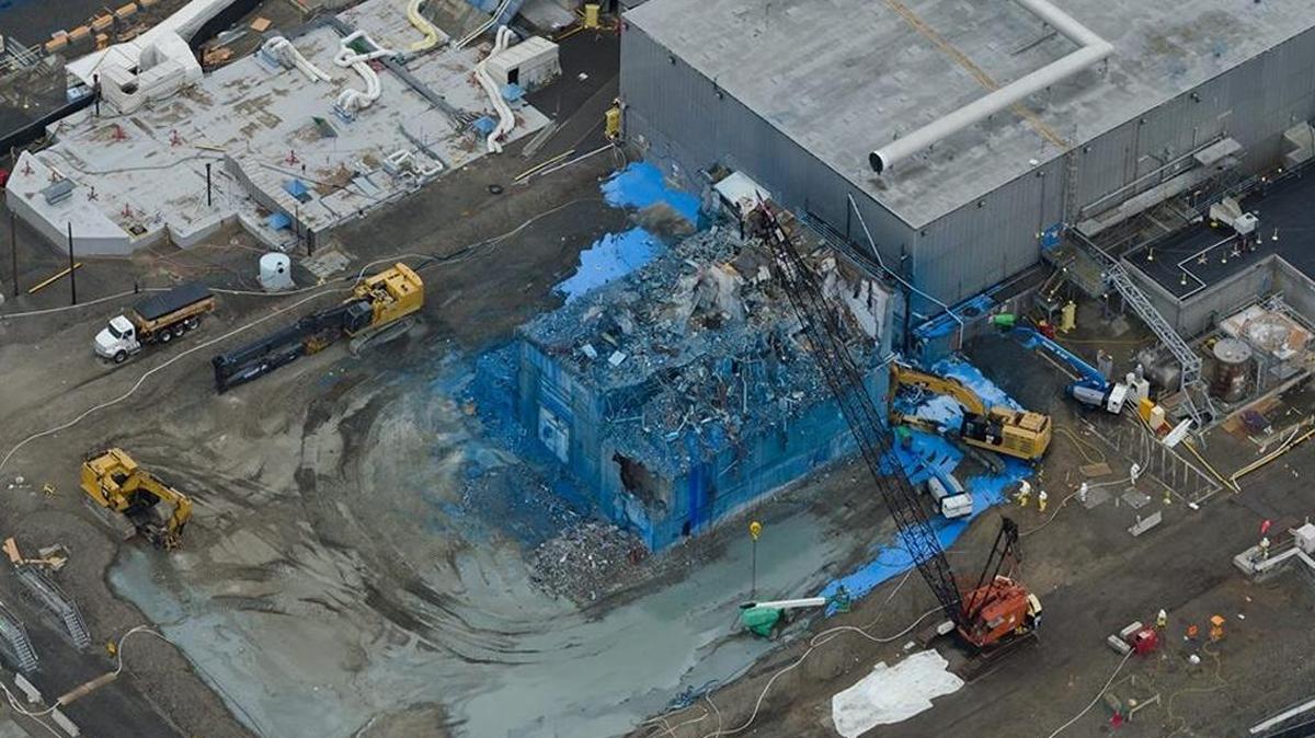 Fixative sprayed on the Plutonium Reclamation Facility to limit contamination spread during demolition has turned it blue.