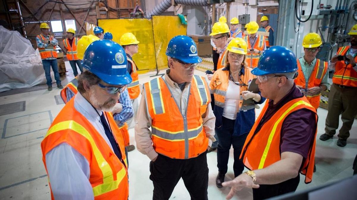 Kevin Smith, right, manager of the Office of River Protection, discusses the Hanford vitrification plant with Energy Secretary Rick Perry, center, during a tour on Aug. 15. Smith plans to retire Sept. 30.