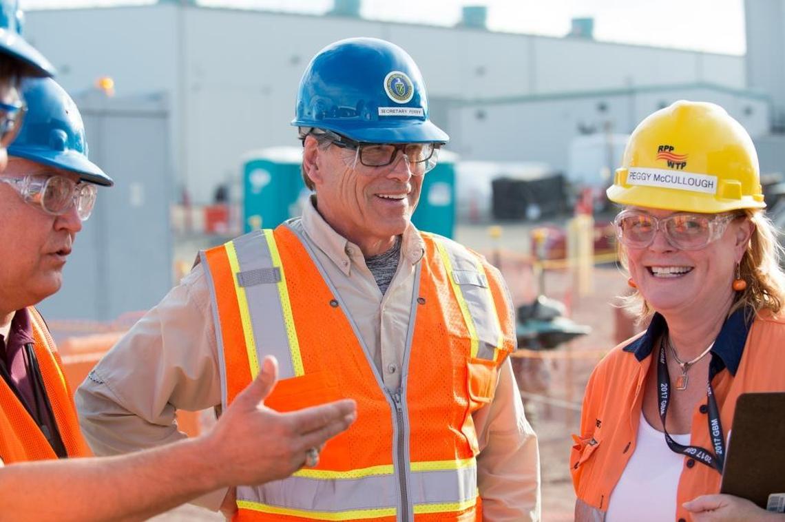 Energy Secretary Rick Perry, center, speaks with Peggy McCullough (right), Bechtel project director for the Waste Treatment and Immobilization Plant, and Kevin Smith, manager of the DOE Office of River Protection.
