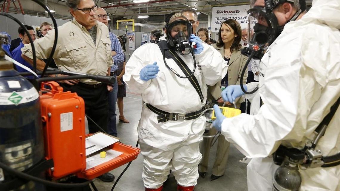 Energy Secretary Rick Perry, left, closely watches as trainers Joni Spencer, middle, and Dean Beaver prepare to give a respirator demonstration Tuesday at the HAMMER training facility. The federal facility offers a variety of training to a variety workers, especially those at Hanford. Rep. Greg Walden, R-Ore., behind Perry and Sen. Maria Cantwell D-Wash., joined the tour. Watch a video at tricityherald.com/video.