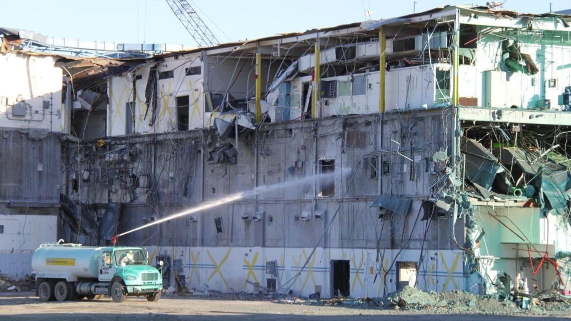 A truck sprays fixative on a pile of demolition debris at the Plutonium Finishing Plant with a goal of preventing radioactive particles from becoming airborne.