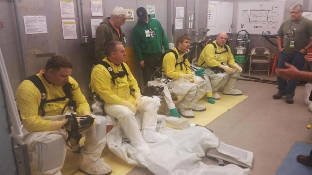 A field work team prepares to enter the Americium Recovery Facility in March 2015.