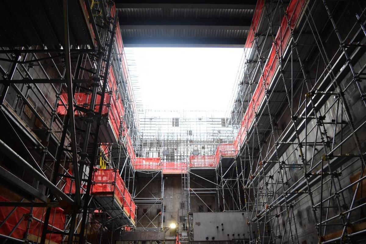 Sunlight shines through an opening above scaffolding installed in the Hanford vitrification plant’s High Level Waste Facility melter cave.