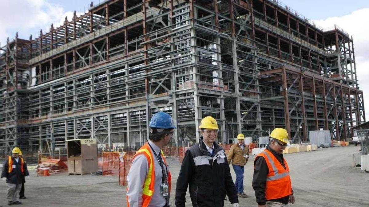 Sen. Ron Wyden, D-Ore., seen in the center wearing black, tours Hanford's vitrification plant in 2013.