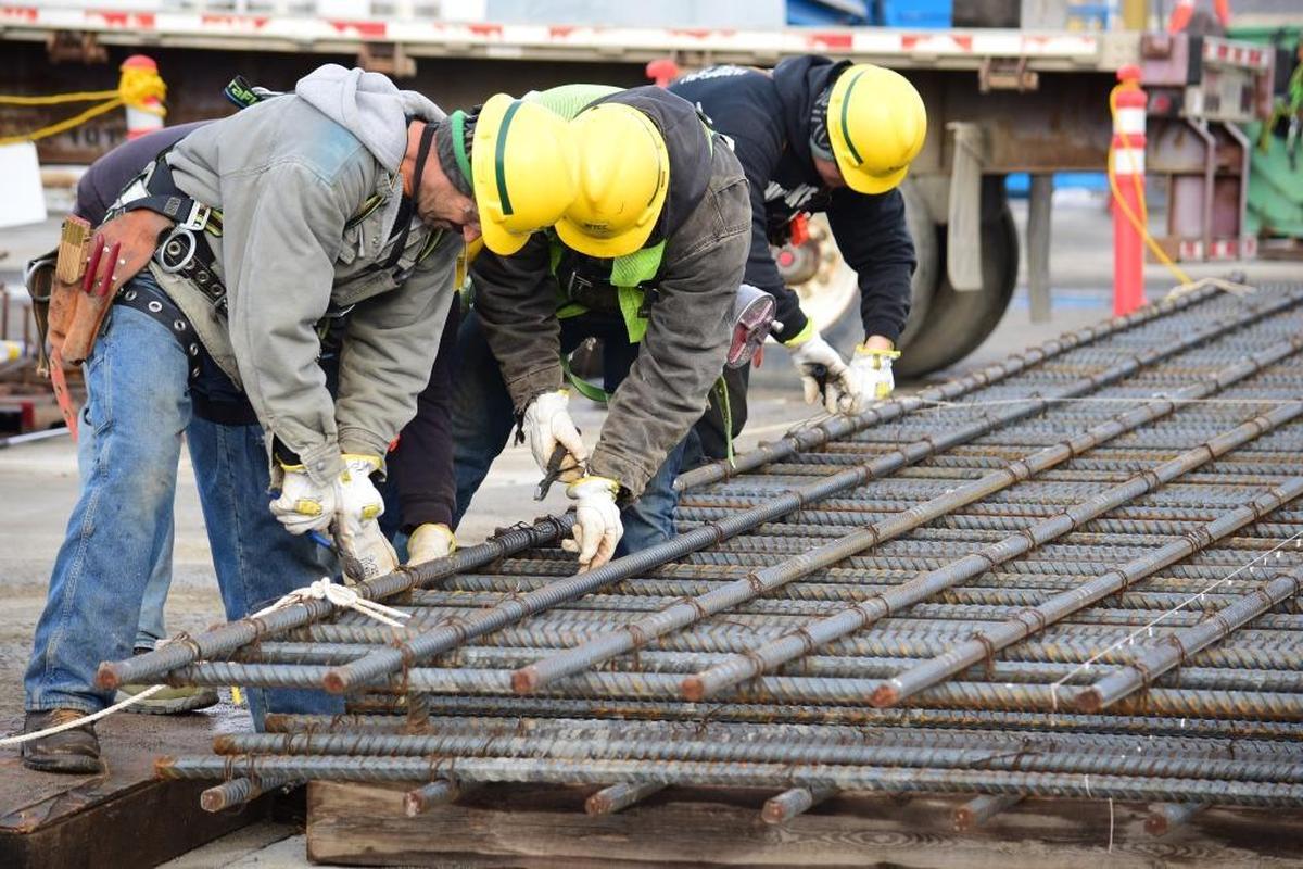 Employees tie and clip rebar before the wall is lifted into the Effluent Management Facility at the Hanford nuclear reservation’s vitrification plant.