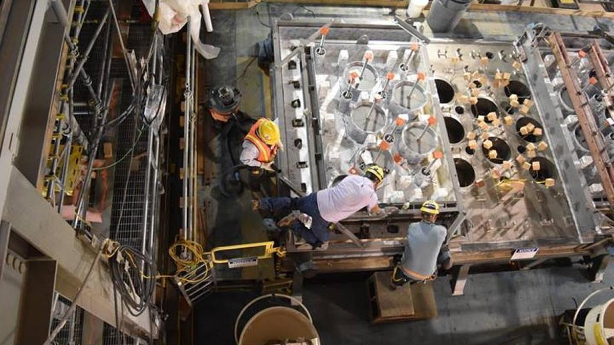
Workers inspect a melter lid at the Hanford vitrification plant’s Low-Activity Waste Facility under construction.
