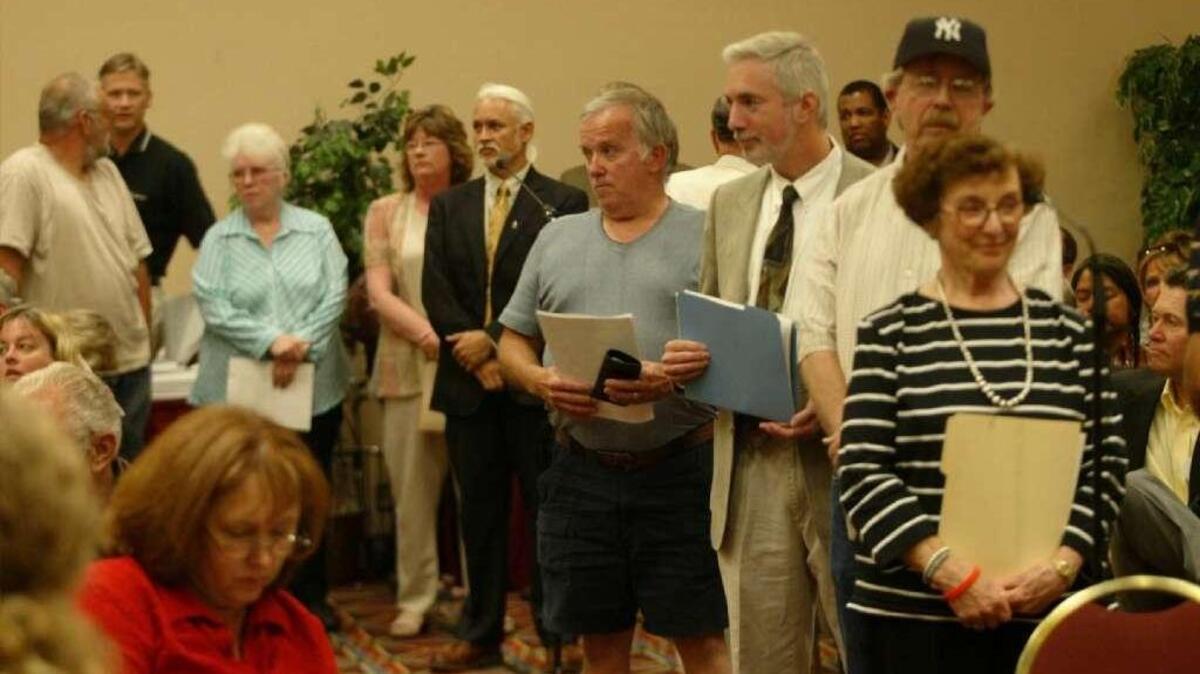 People line up to ask questions of Hanford officials at an earlier State of the Site meeting.