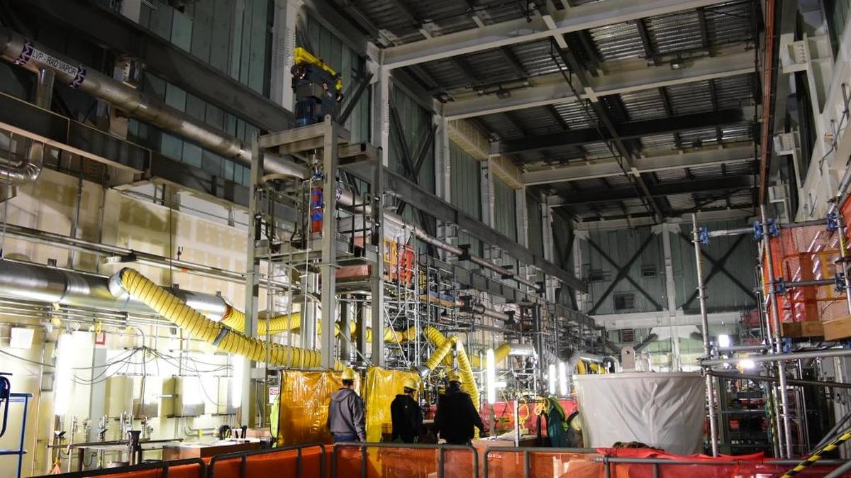 Employees walk through the large Low Activity Waste Facility process cell bay at the Hanford nuclear reservation’s vitrification plant construction project.