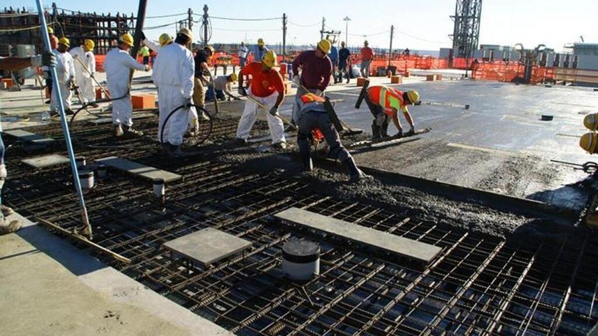 Workers place about 130 cubic yards of concrete for a slab at the top of the vitrification plant’s High Level Waste Facility.