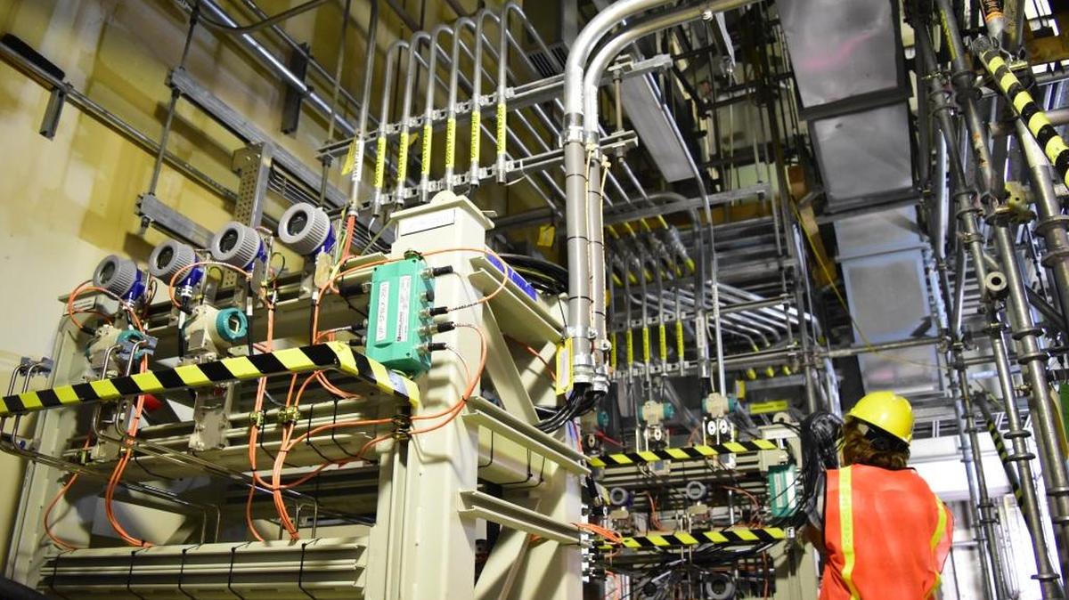 A worker looks upwards at the Hanford vitrification plant’s Low Activity Waste Facility’s complex infrastructure of electrical raceway, cable and wiring. Contractor Bechtel National Inc. is on pace to finish construction of the facility by June.