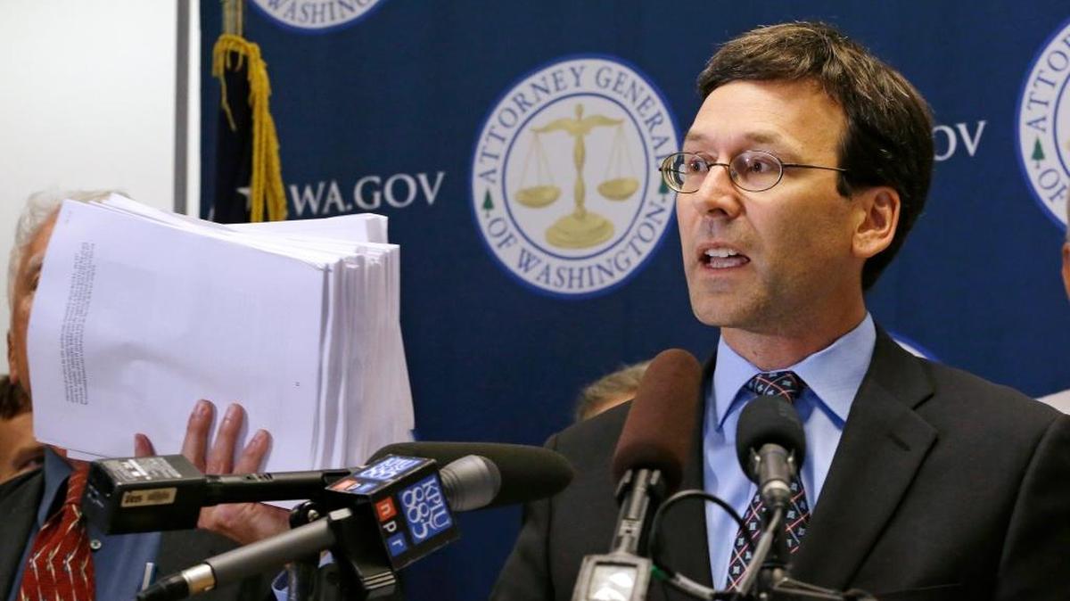 
Washington Attorney General Bob Ferguson holds up 19 reports and studies done on worker exposure to chemical vapors from waste held in Hanford tanks. He announced a new lawsuit at a Seattle press conference Wednesday.

