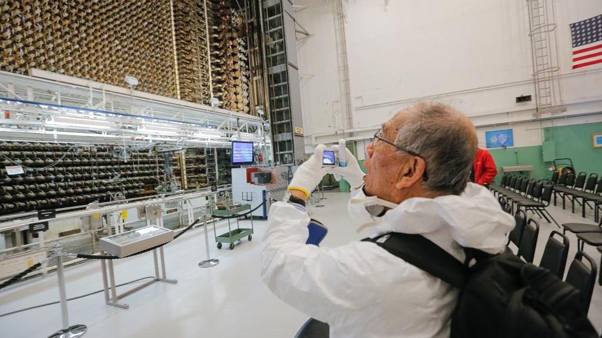 Mitsugi Moriguchi takes a photo of the front face of the reactor inside Hanford’s B Reactor on Friday. When the nuclear reservation was producing plutonium that would be used in the atomic bomb dropped on Nagasaki, Japan, Moriguchi was a child living in Nagasaki.