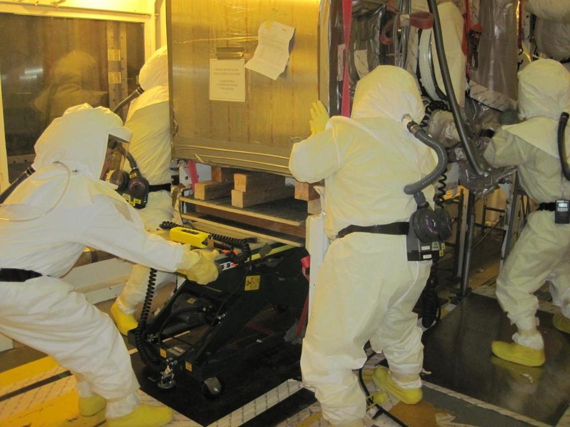 Hanford workers pull out a highly contaminated glove box at the Plutonium Finishing Plant, much of which is now demolished. More than 30 workers have inhaled or ingested small amounts of radioactive particles during demolition of the plant.