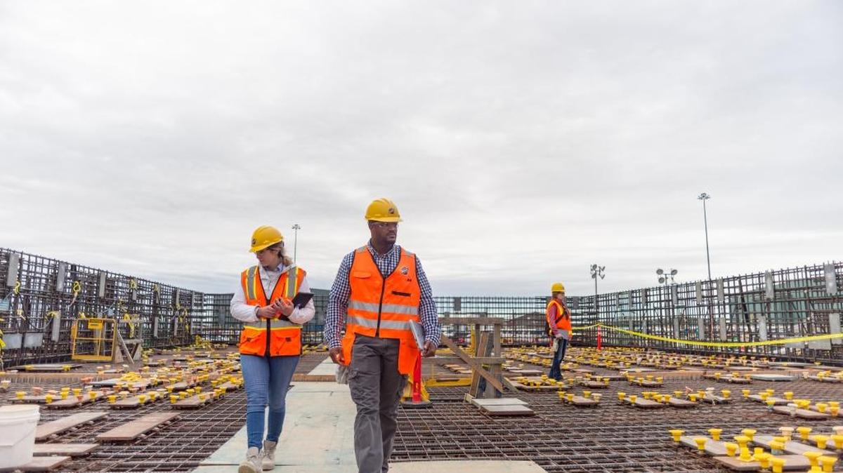 Employees walk around the Effluent Management Facility under construction at the Hanford vitrification plant. The building is needed to meet a 2023 deadline to start glassifying low-activity radioactive waste.