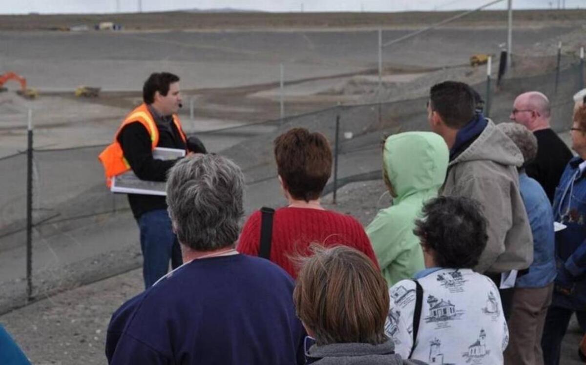 Participants in a Hanford tour get a look at work at the massive central Hanford landfill for low level radioactive and hazardous chemical waste.