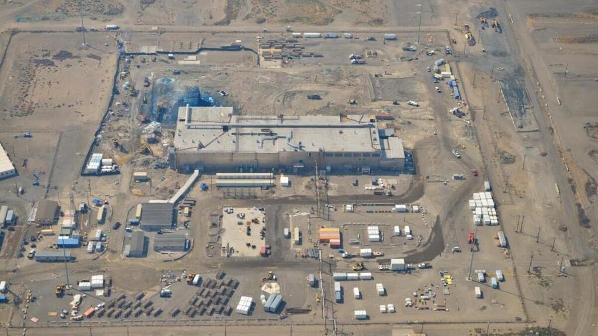 The Plutonium Finishing Plant is shown from the air as it looked in August. The blue area is where fixative has been sprayed at the former McCluskey Room and the plant’s Plutonium Reclamation Facility to control airborne contamination during demolition using heavy equipment.