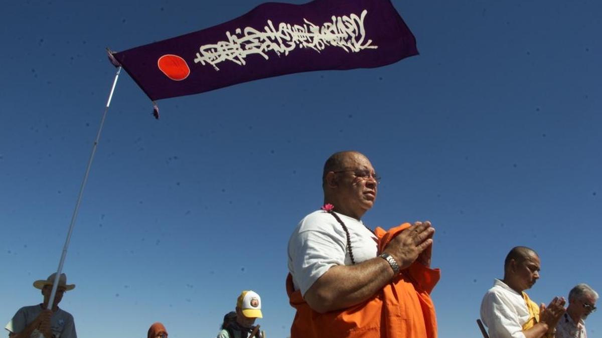 Buddhist monks Gilberteo Perez and Senji Kanaeda, at right, with the Nipponzan Myohoji Buddhist Temple on Bainbridge Island, pray at the gates of the Hanford 300 Area.