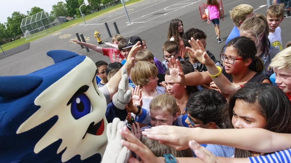 Dusty, the Tri-City Dust Devils mascot, gives out high-fives and celebrates with fifth-graders at Lewis & Clark Elementary School in Richland after being named the most active students in a Kadlec Regional Medical Center program. The exercise program keeps students active and healthy by wearing Sqord fitness bands. Ten Tri-City schools were in the competition. Watch a video at tricityherald.com/video.
