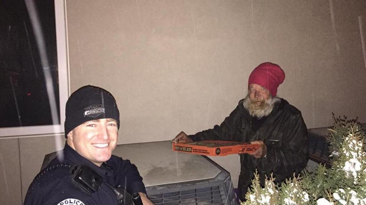 Officer Travis Parka and Robert share some pizza.