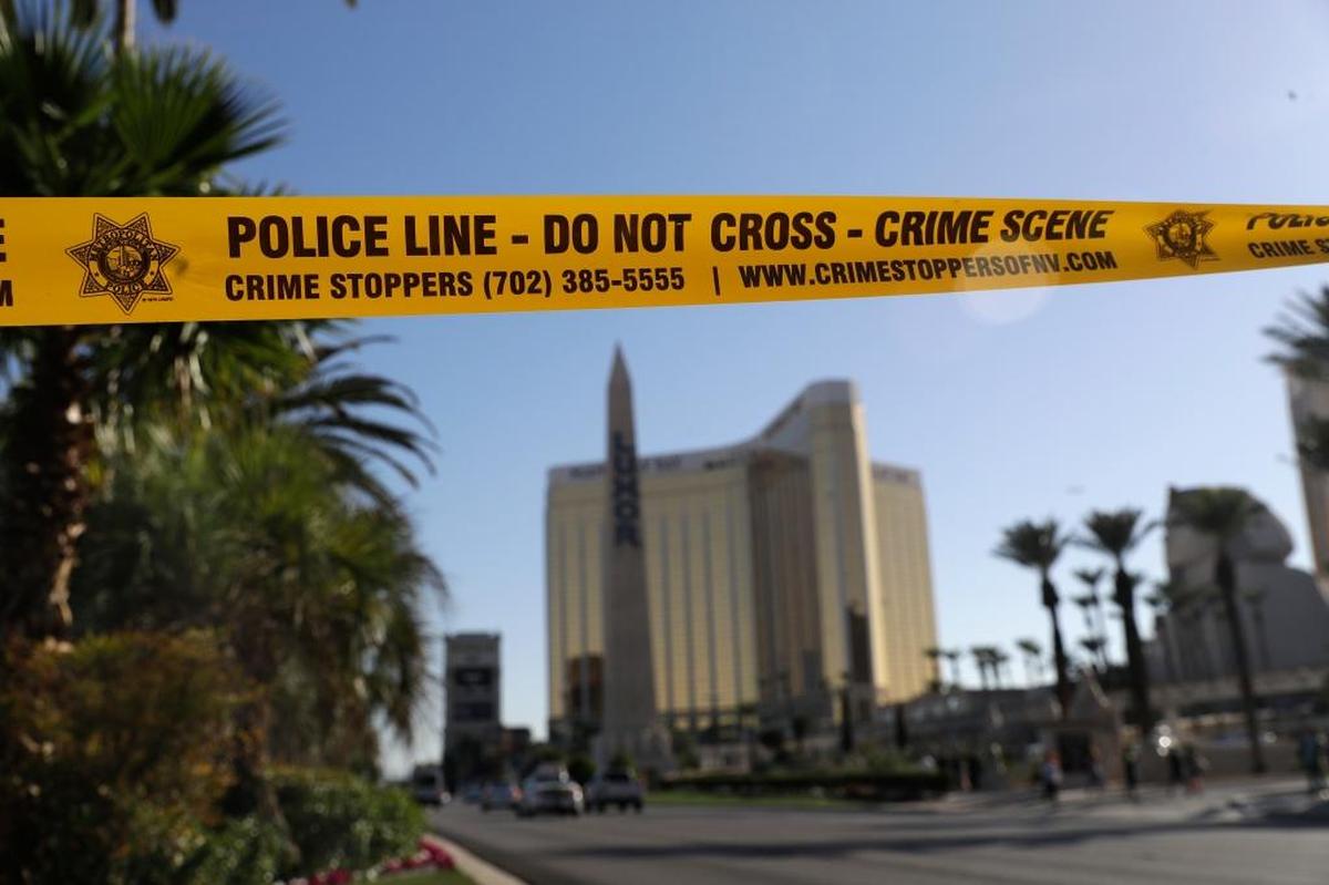Part of Reno Avenue near South Las Vegas Boulevard is blocked Wednesday with police tape in the aftermath of a mass shooting. It was the deadliest mass shooting in modern U.S. history, with dozens killed and hundreds injured, some by gunfire, some during the chaotic escape.