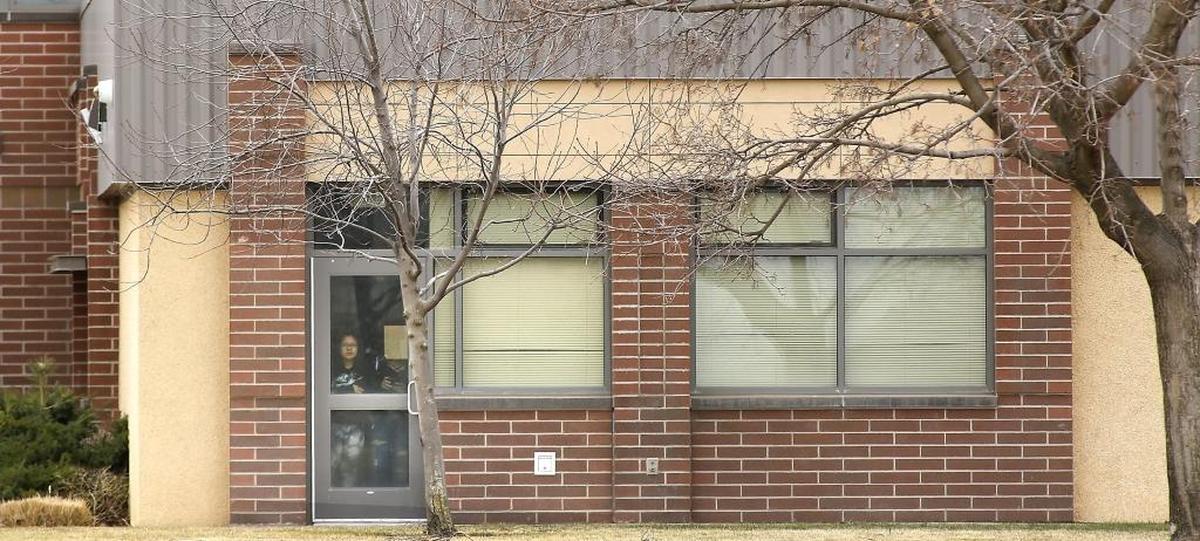 People look out a door at Kiona-Benton City High School during a lockdown after a rumor that a student brought a gun to the school. Officials said no gun was found.