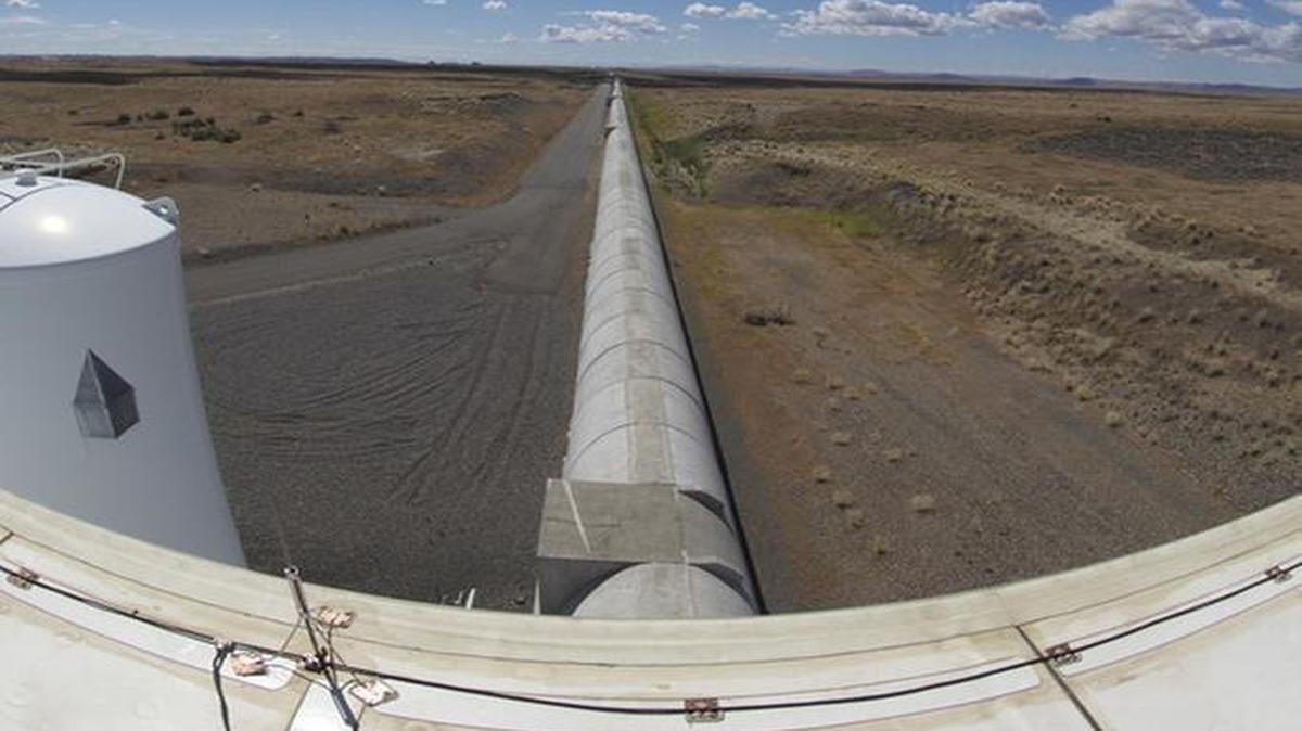 A view from the end station of one of LIGO Hanford’s interferometer arms looking in the direction of the corner station where the two arms meet 2.5 miles away. LIGO’s vacuum tube is protected by concrete housing.