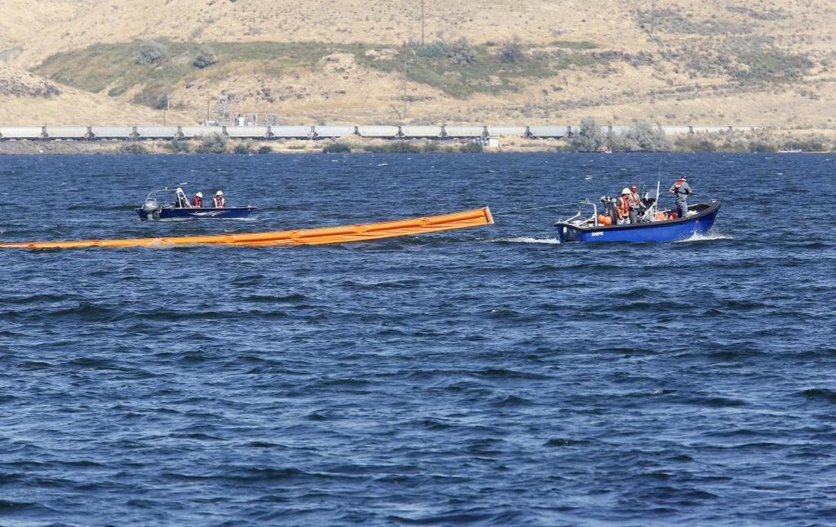 A boat towing a protective oil spill boom heads up the Columbia River in front of the McNary Yacht Club at Hat Rock State Park near Hermiston on Wednesday as part of an oil spill training exercise. Watch a video at tricityherald.com/video.
