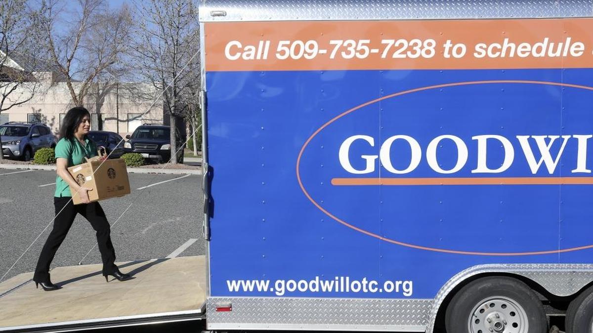 Lorie Orozco, from Trios General Health, carries donations Wednesday into a Goodwill trailer parked outside the Trios Care Center at Vista Field on North Young Street in Kennewick. Her “Trios Trots" Relay for Life team is using the trailer to gather donations. For each pound collected they receive 10 cents from Goodwill. The trailer is open for donations 8 a.m. to 8 p.m. through April 3. See a video at www.tricityherald.com.