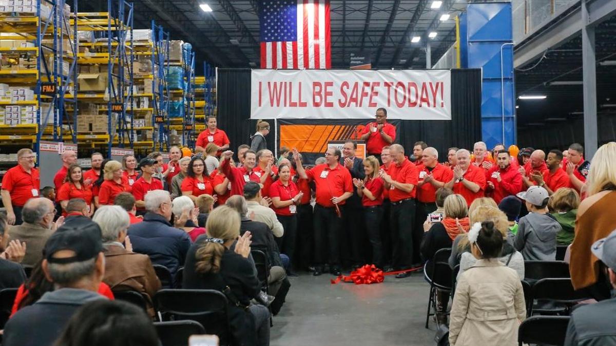 AutoZone employees gather for the ribbon cutting ceremony for the company’s new 443,819-square-foot distribution center and truck maintenance yard in Pasco on Saturday. It will employ about 250 people.