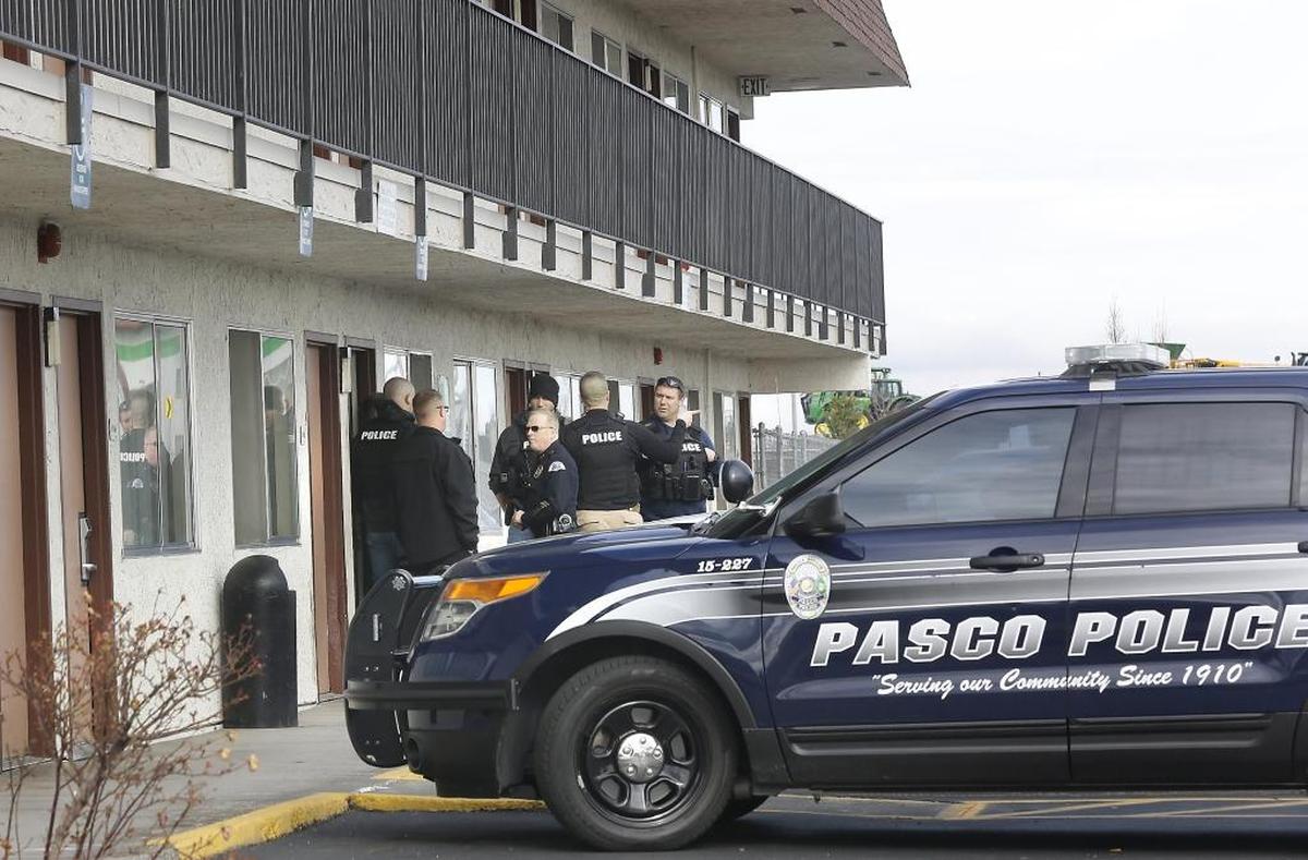 Pasco police stand outside the room at the Rodeway Inn where stabbing suspect Hector Orozco Jr. was arrested Wednesday in connection with the stabbing death of Demetrius Graves.