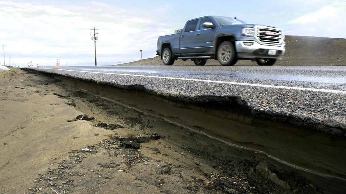 The Washington Military Department is assessing flood damage in Benton, Franklin and 13 other counties with an eye toward asking Gov. Jay Inslee to declare a state of emergency so it can pursue federal repair funds. Above, Glade North Road, between Alder and Eltopia West road, was closed after being compromised by melting snow and ice in Franklin County.