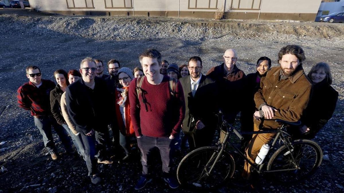 Adam Brault, center, is joined by other supporters of the “Grand Bargain,” a package of public facilities districts, for a group photo at the pit along George Washington Way in Richland. Brault is an unofficial spokesman for the group working to link Pasco’s aquatics center dreams to Kennewick’s performance center and Richland’s public market without much support from public officials.