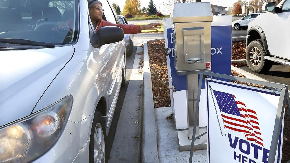 Kennewick resident Derrick Marshall stretches to reach the ballot drop box Monday morning in the parking lot at the Benton County Annex at 5600 W. Canal Dr. in Kennewick. Deadline for ballots to be mailed or dropped off is 8 p.m. Tuesday. There are many city, school district and county races to be decided this general election.