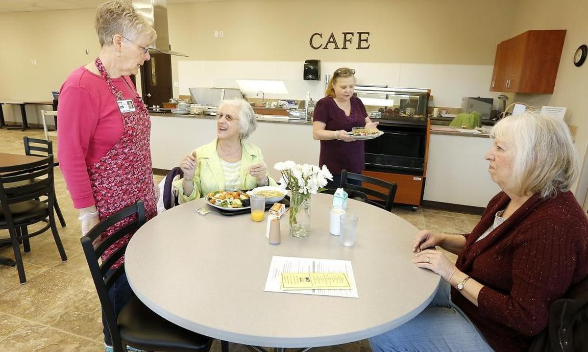 Volunteers and clients share smiles at the Meals on Wheels Senior Dining Cafe in Richland in this file photo.