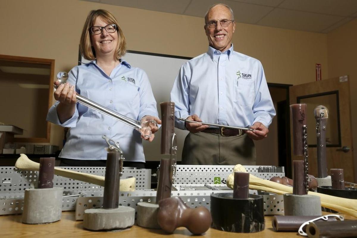 Dr. Lewis Zirkle, SIGN founder and president, and CEO Jeanne Dillner stand with equipment, implants and other orthopedic tools. Secretary of Defense James Mattis will be in town late February to give Zirkle the Department of Defense’s Medal for Distinguished Public Service.