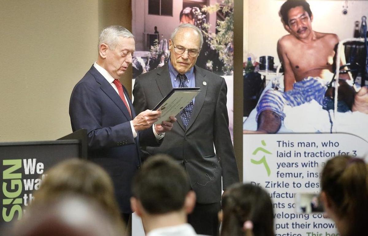 Secretary of Defense James Mattis, left, presents the Medal for Distinguished Public Service to Dr. Lewis G. Zirkle on Monday in Richland. Zirkle’s SIGN Fracture Care makes and donates orthopedic instruments and implants for use in developing countries. Watch a video at: tricityherald.com/video.
