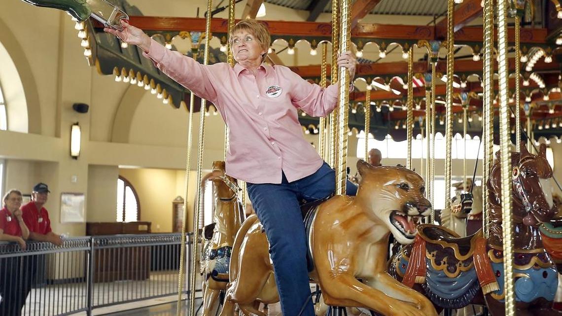 Barbara Straight of Kennewick reaches for a ring while riding the Gesa Carousel of Dreams last September during the All Senior Picnic at the Southridge Sports and Events Complex in Kennewick. The carousel is expected to have its 250,000th rider sometime late next week.